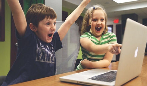 Excited kids on laptop