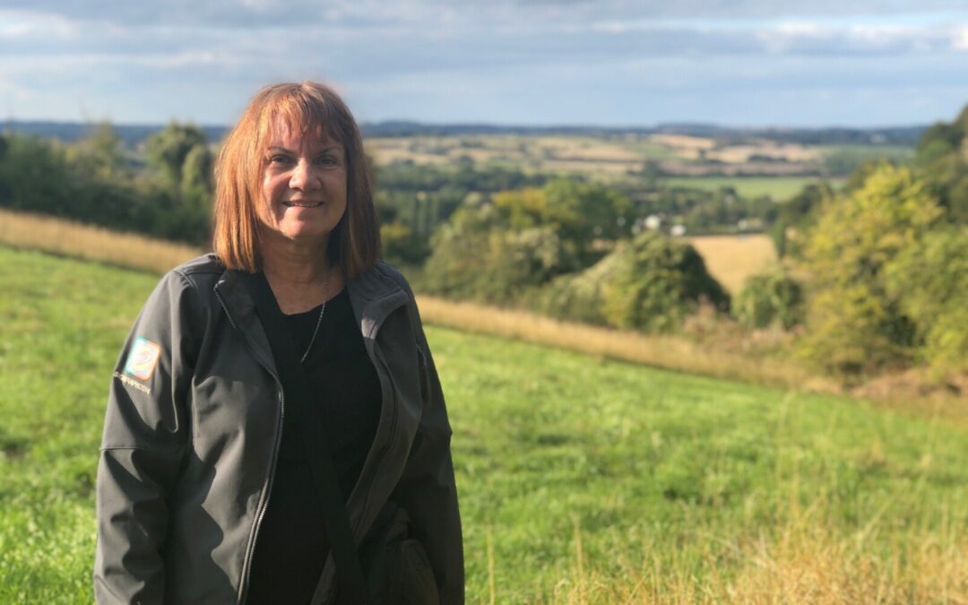 Jackie White on a grassy hill